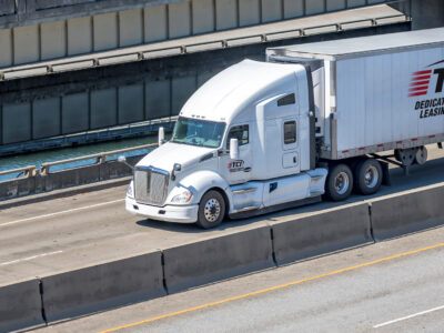 Sleeper Cab pulling reefer trailer down highway