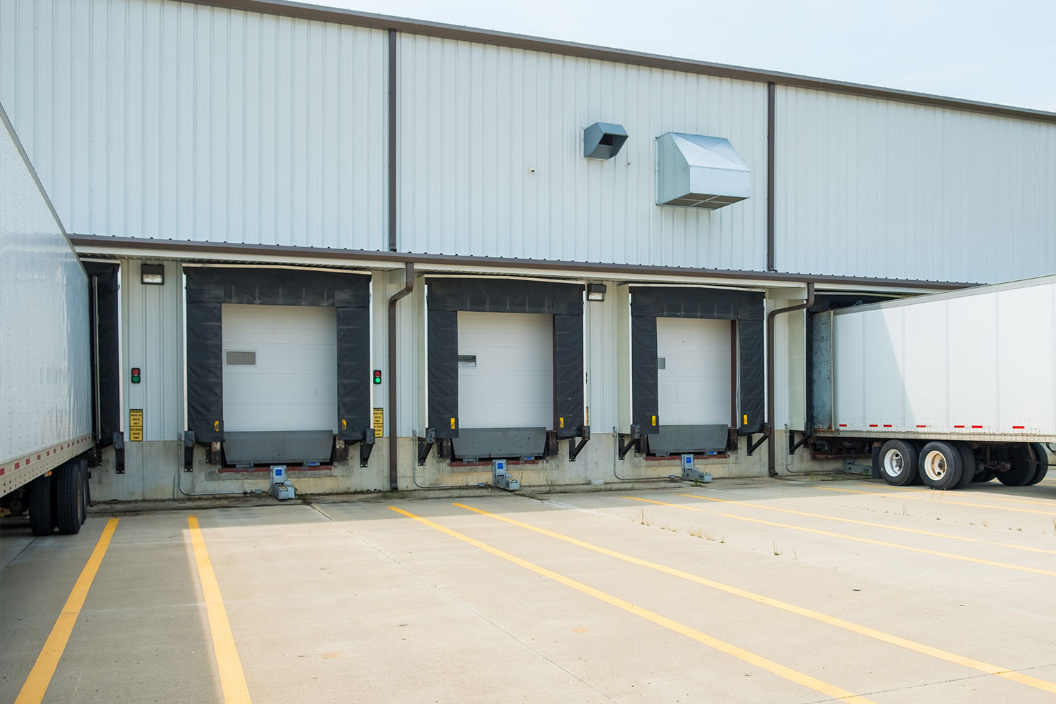 Warehouse building with 53 foot dry van trailers backed into docking doors