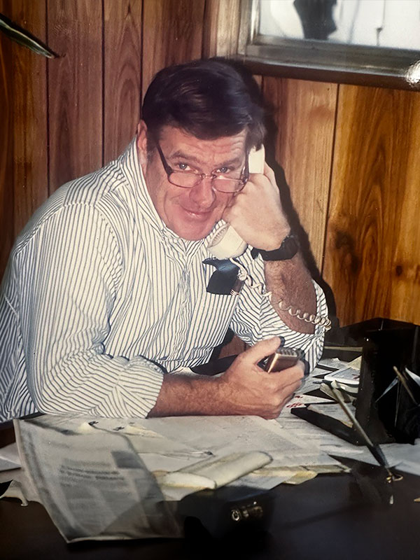 Gerry Flynn in the early 1980's at his desk on the phone