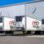 A row of White TCI Reefer Trailers at loading docs.