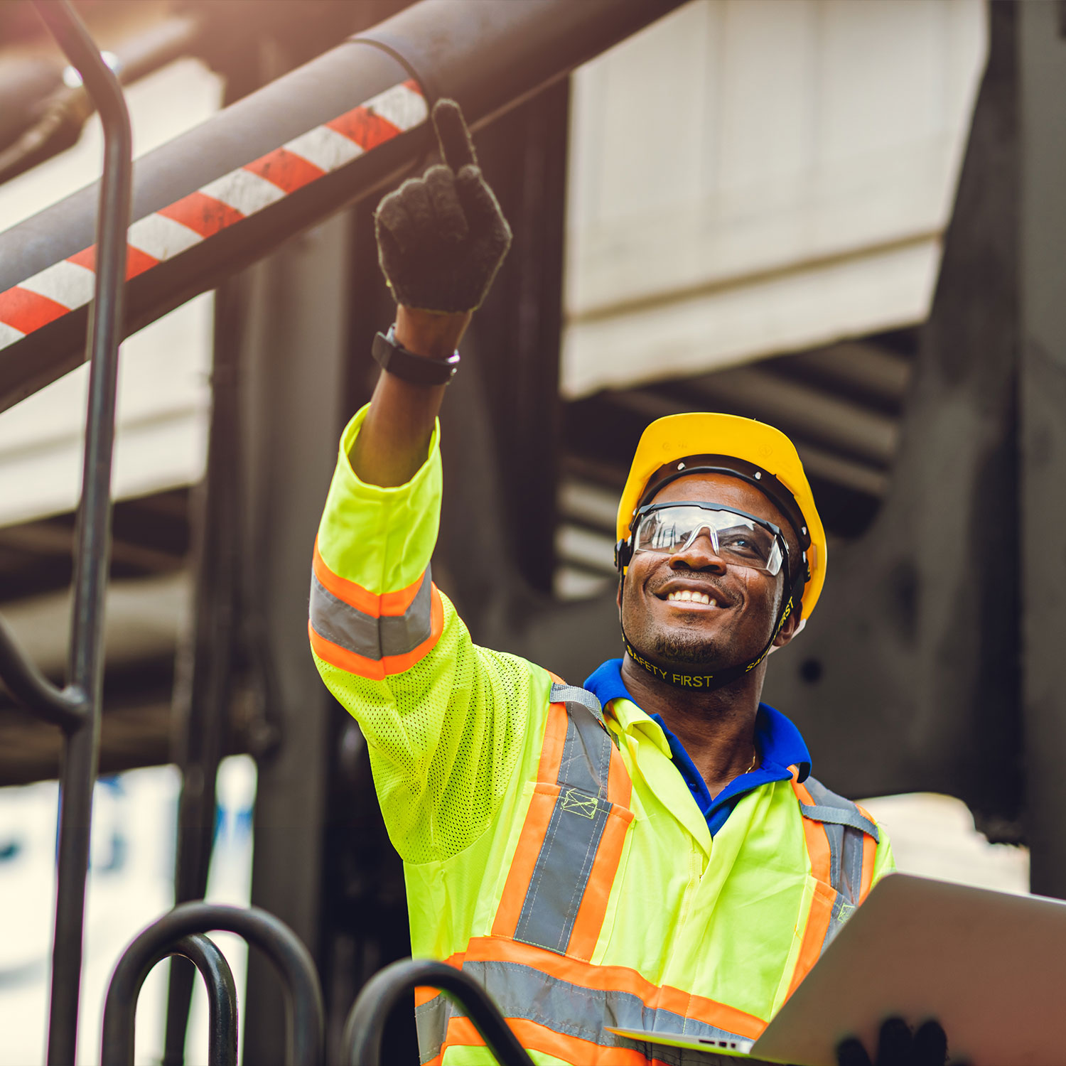 Foreman loading cargo in shipping logistic warehouse with safety suit