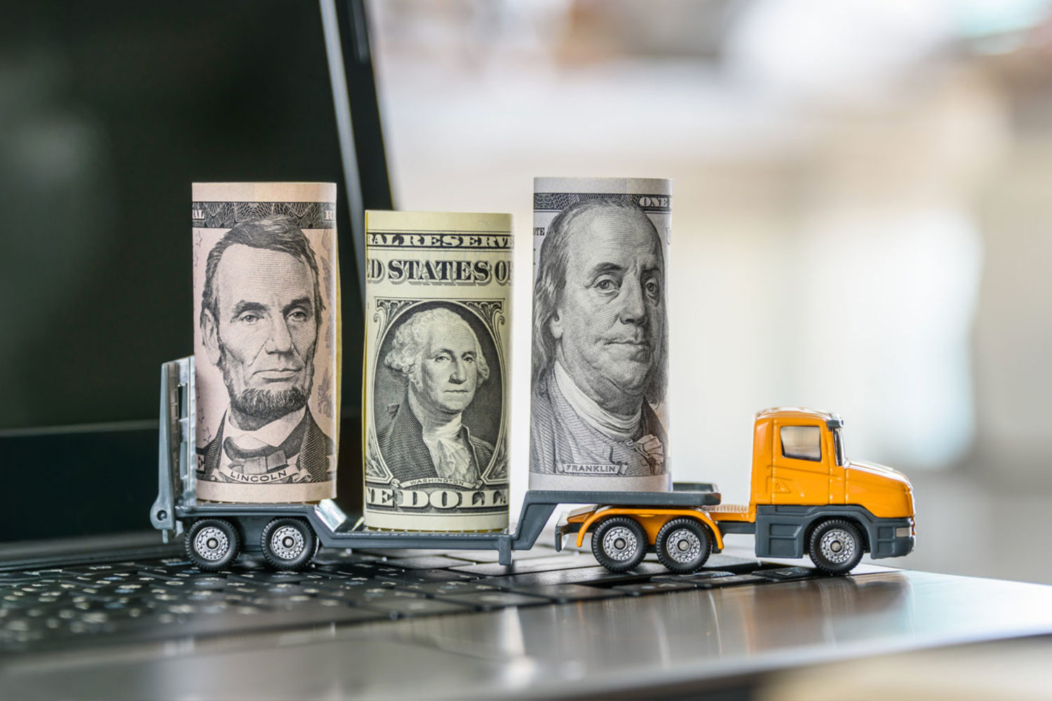 Rolls of money on the back of a toy flatbed truck